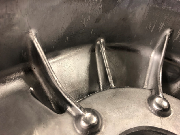 Die casting with ribs connecting the outer wall to another feature