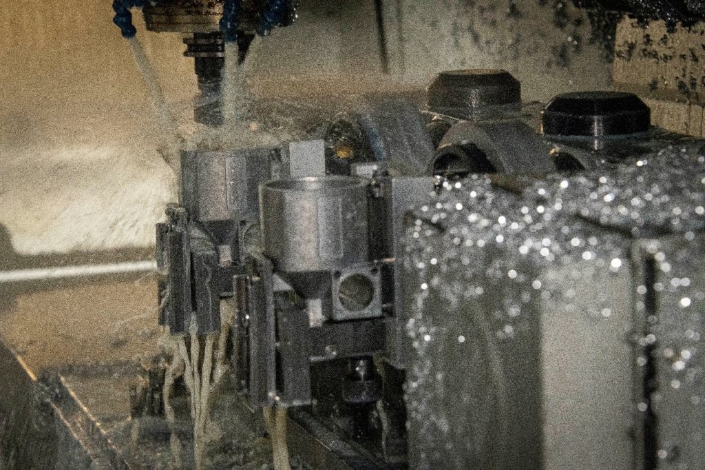CNC machining center finishing an aluminum die cast part